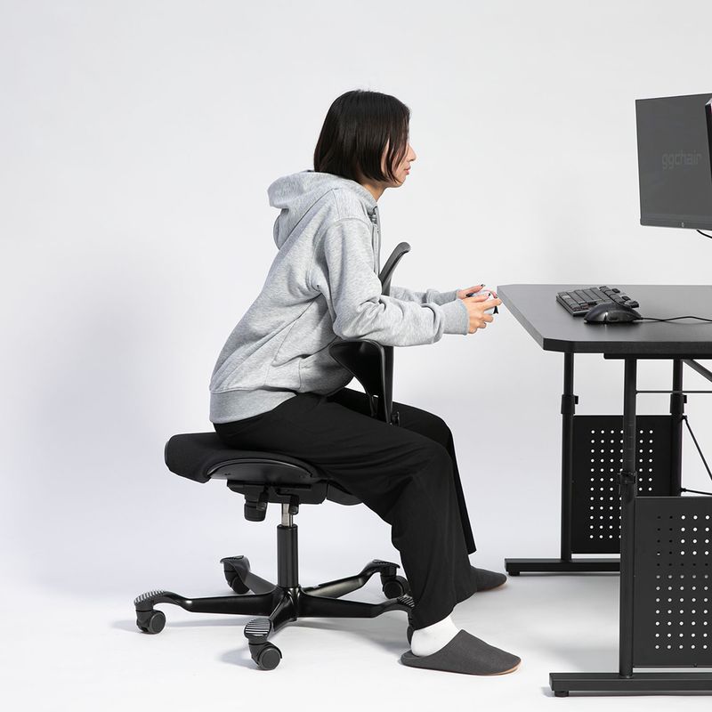 背もたれを前にして前傾姿勢でプレイする様子